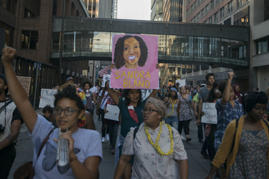 Image of march to honor Sandra Bland and protest deaths of black women in police custody taken July 31, 2015 by Fibonacci Blue, originally posted on Flickr.